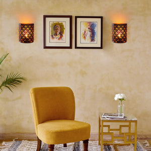 Set of 2 8''H battery-operated wall sconces with dark perforated metal shades and warm amber glow.