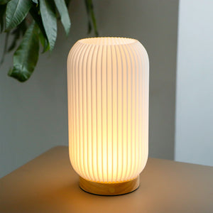 9-inch tall rechargeable cylindrical lamp with ribbed white body and warm light