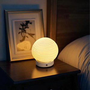 JHY DESIGN Ceramic Ball Rechargeable Lamp (Planet); cordless table lamp with white swirled ceramic globe on white base.
