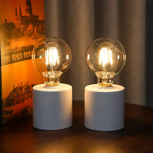 Set of 2 white battery-operated table lamps by JHY DESIGN, 7 inches tall with clear bulbs on white bases.