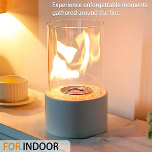 Tabletop fire bowl pot fireplace by JHY DESIGN, glass hurricane with pebble bed and blue base; two items on table.
