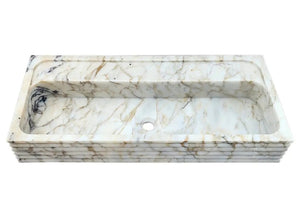 Calacatta Viola gold marble wall-mount sink, rectangular basin with fluted edge, white with gold veins.