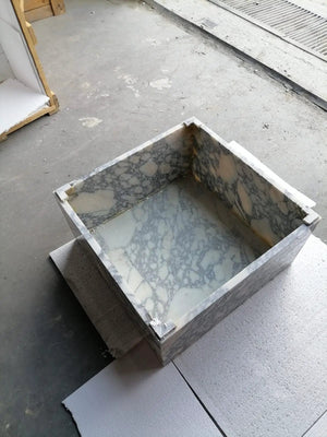 Calacatta Viola marble rectangular prism coffee table block design, white with gray veining, in a mold.