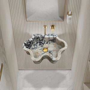 Calacatta Viola marble wall-mount bathroom sink with wavy edges and gold faucet