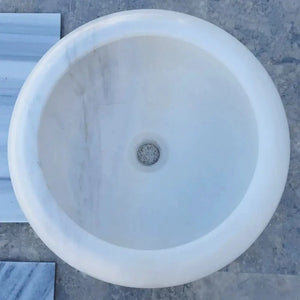 Carrara white marble round above-counter bathroom sink, polished finish, 15.5-inch diameter.