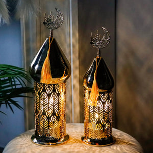 Set of 2 gold electric candle lanterns with ornate cutout metalwork and orange tassels