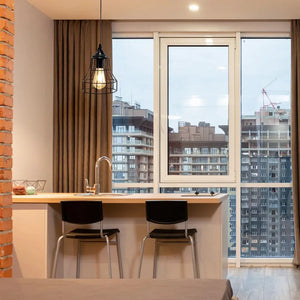 9.5H black geometric cage pendant lamp, battery-powered, hanging above a kitchen island.