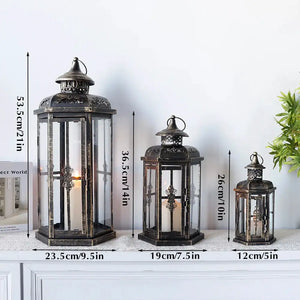 Set of 3 decorative candle lanterns, black with gold brush accents.