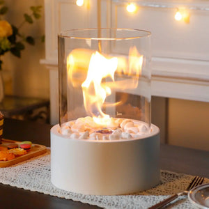 Extra large portable tabletop bio-ethanol fire bowl with clear glass cylinder and pebble base.