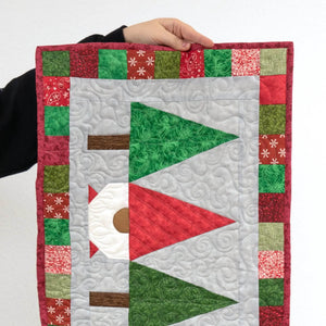 Quilt kit Christmas Gnomes table runner by Block Party Quilt Co; precut red, green and white patchwork with quilting.