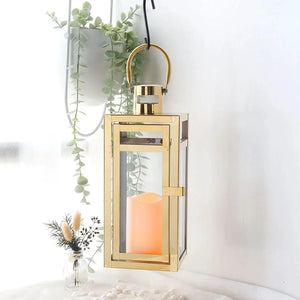 12'' High Metal Decorative Candle Lantern in gold with glass panels and hanging loop.