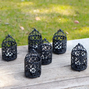 Set of 6 black metal hanging birdcage tealight lanterns with ornate lattice design.