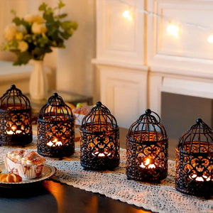 Set of 6 black metal hanging birdcage tealight lanterns with warm candlelight