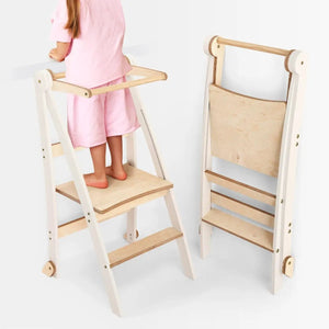 Helper Tower toddler step stool in white frame with natural wood steps; foldable, two towers shown