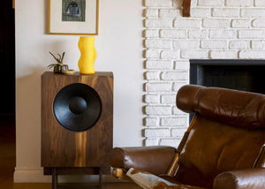 Woogie table lamp by Terra Labs; bright yellow, sculptural wavy design on a wooden console.