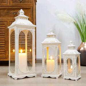 Set of 3 cream white decorative candle lanterns in 10, 14, and 19.5 in heights with glass panels