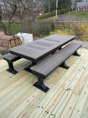 Trestle X Outdoor Bench, gray-stained wooden table with attached benches on black trestle bases.