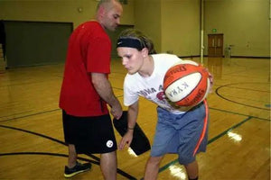 Defender Extender Basketball Training Pads in use during a gym drill by two players