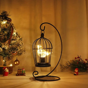 12-inch tall battery-operated birdcage lamp in black metal with warm fairy lights on a curved stand by JHY DESIGN