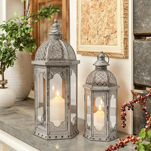 Set of 2 vintage metal candle lanterns, grey with black brush finish, glass panels and lit candles inside