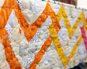 Linked Hearts Quilted Table Runner Kit by Block Party Quilt Co; orange, cream and aqua patchwork.