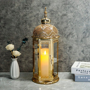 Moroccan candle lantern, 15-inch gold hexagonal metal lamp with glass panels and lit candle.
