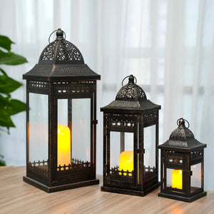 Decorative candle lanterns set of 3 in black metal with intricate lattice panels and warm candlelight