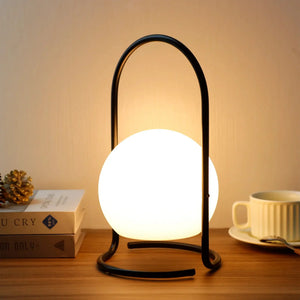 Portable table lamp with circular metal ring and glowing globe; 2600mAh rechargeable, waterproof.
