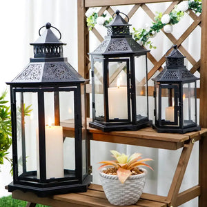 Set of 3 black hexagonal decorative candle lanterns in 18, 13 and 10 inch heights with glass panes and candles inside