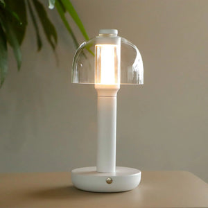 10-inch table lamp with clear glass shade and white base; battery-powered, dimmable 3-color light.