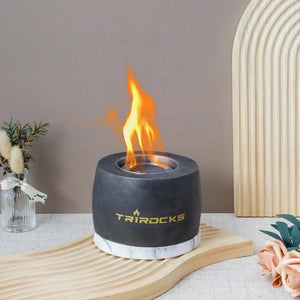 Black graphite cement portable fireplace with TRIROCKS logo; gel/ethanol fireplace for home use.