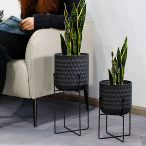 Set of 2 tall black metal flower pots on stands, 12 and 18 inches tall, with hammered texture