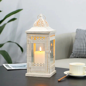 Decorative candle lantern, beige with gold-brushed accents, vintage metal, lit candle inside
