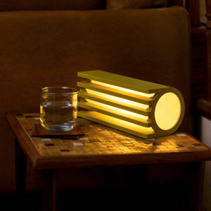 Radiator Table Lamp Terra Labs, pale yellow metal with radiator-inspired design and warm glow.