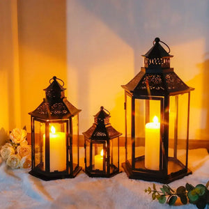 Set of 3 black hexagonal decorative hanging candle lanterns with lit candles by JHY DESIGN