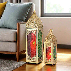 Set of 2 Moroccan candle lanterns with gold metal frames and red and green stained glass panels.