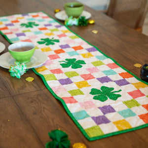Shamrocks Rainbow Table Runner Precut Quilt Kit by Block Party Quilt Co; multicolor squares with green border