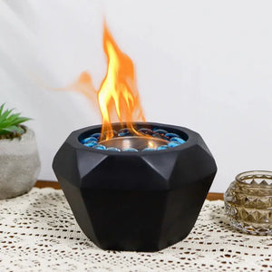 6x4 inch portable cement tabletop fireplace in black with blue glass stones and a gel/ethanol flame