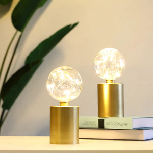 8-inch tall gold battery-powered table lamps, set of 2, with clear glass globe bulbs.