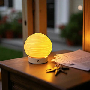 Ceramic Ball Rechargeable Lamp (Planet) by JHY DESIGN; cordless table lamp with warm yellow glow.