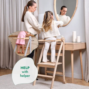 Helper Tower wooden foldable toddler step stool by Goodevas with rails, shown beside a wooden dresser