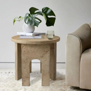 Troia light travertine round end table with U-shaped legs.
