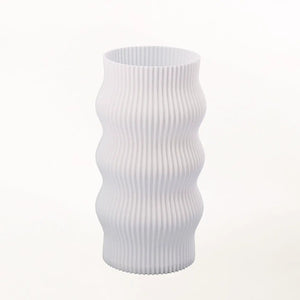 Wub Table Lamp by Terra Labs, white ribbed lamp with vertical wavy ridges.