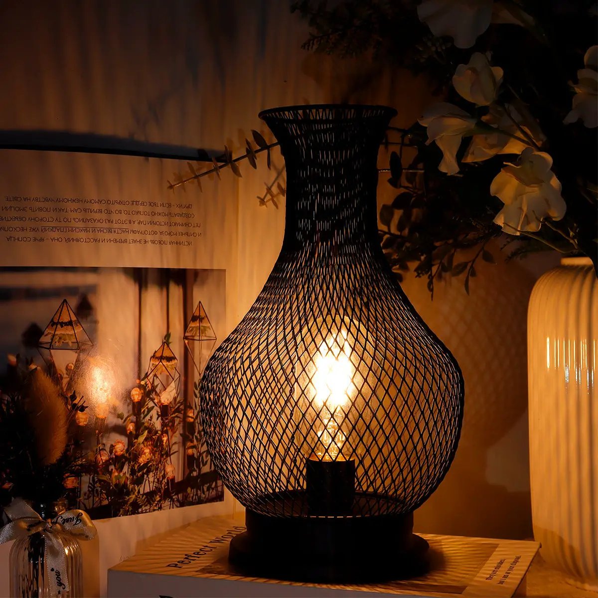 11-inch tall cordless battery-operated lamp with LED Edison bulb in black mesh lantern, warm glow.