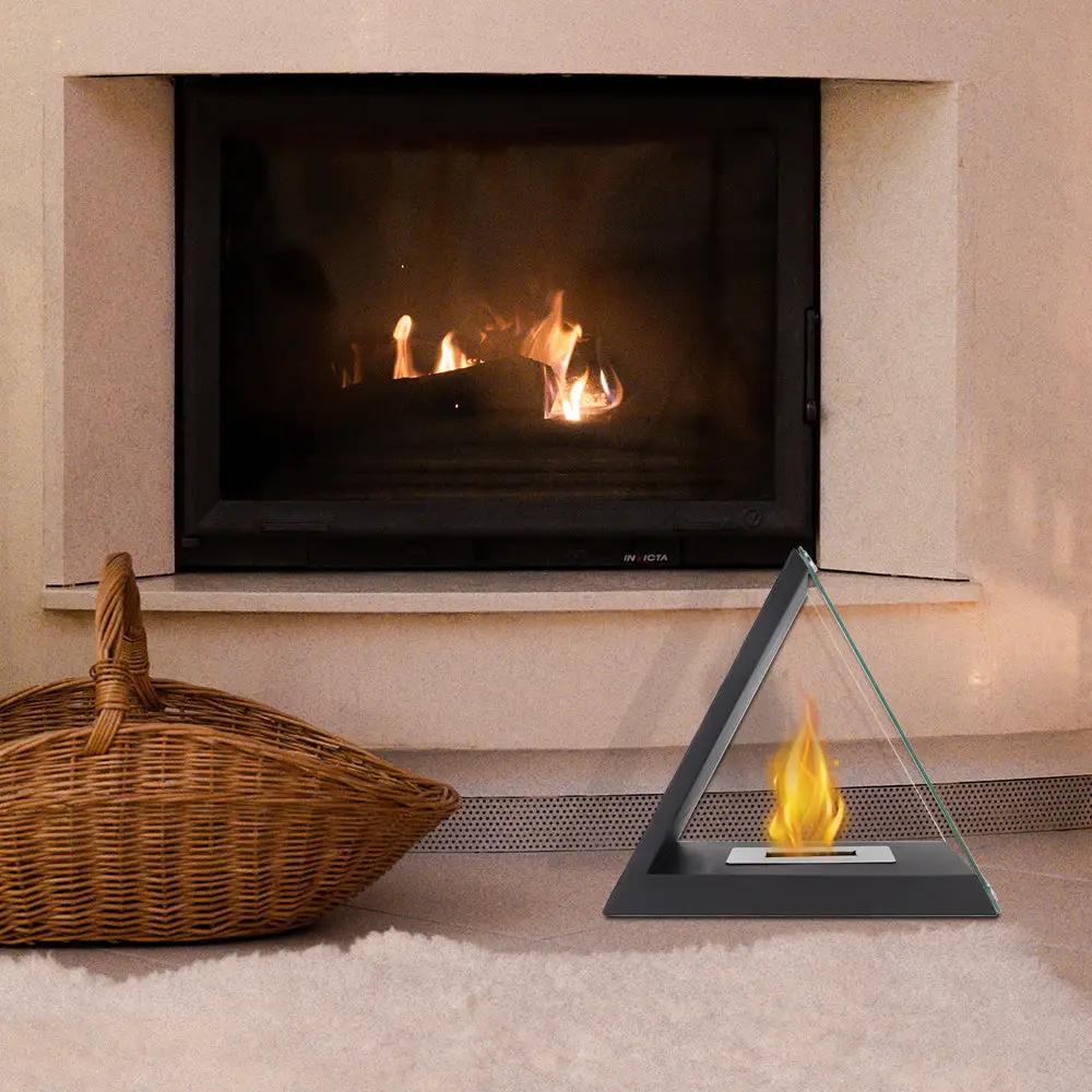 Glass tabletop fireplace by JHY DESIGN; triangular glass panel with black base.