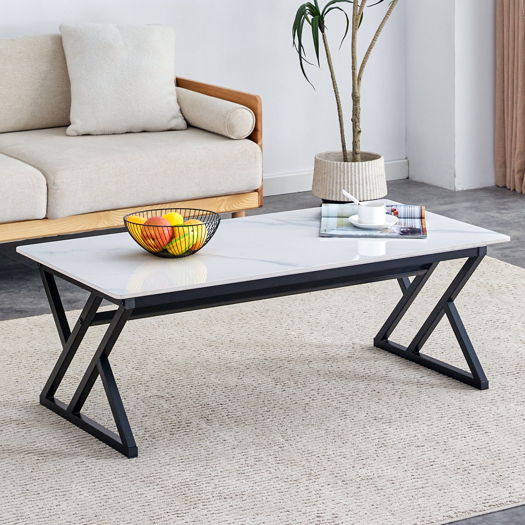 A coffee table made of rock slab material, with a smooth and natural surface that complements the modern design of the black metal legs, making it suitable for living rooms of all sizes.47*23.6
