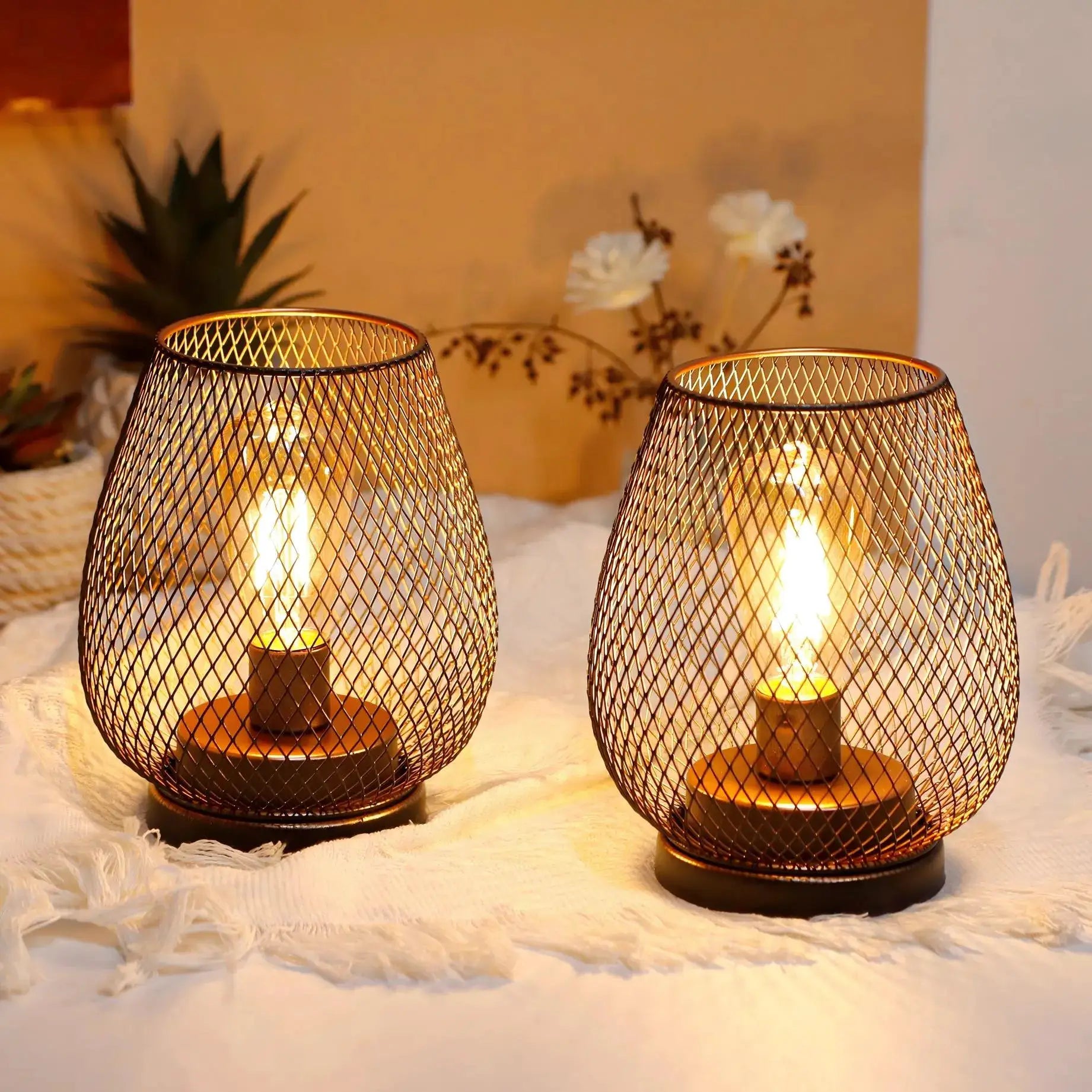 6.7-inch tall battery-powered outdoor table lamp pair with bronze metal mesh shade and warm glow.