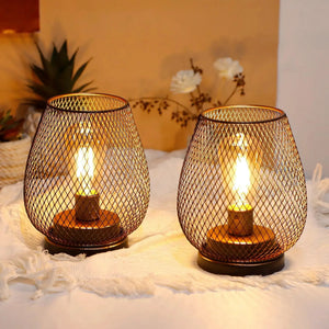 6.7-inch tall battery-powered outdoor table lamp pair with bronze metal mesh shade and warm glow.