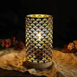 7.5in high metal cordless lamp with an intricate perforated pattern and warm glow on a wooden base