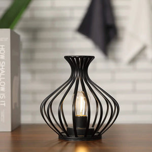 7.5in LED wireless table lamp with black metal wireframe and exposed bulb.